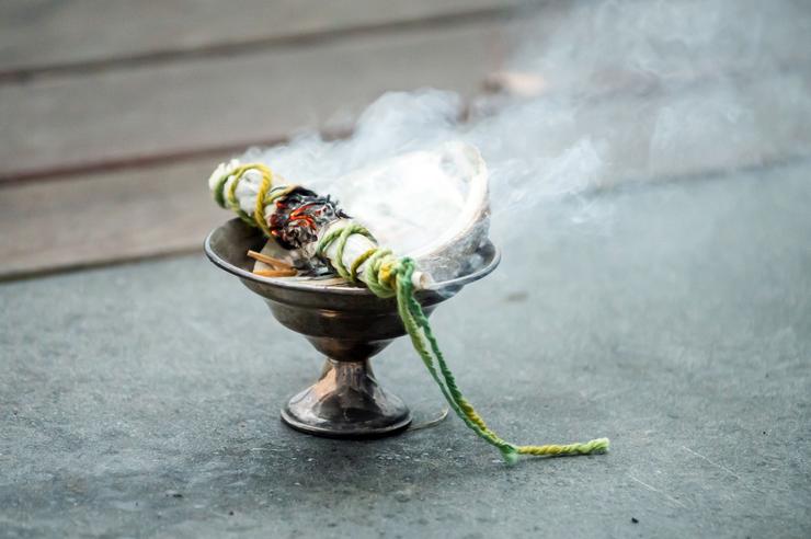 smudge stick smolders and sends up smoke